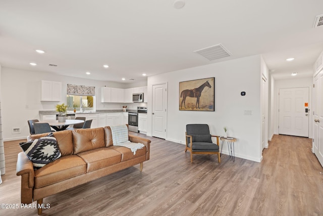 20163 E Cedar Canyon Dr, Mayer, AZ 86333 - living room featuring light wood finished floors and recessed lighting