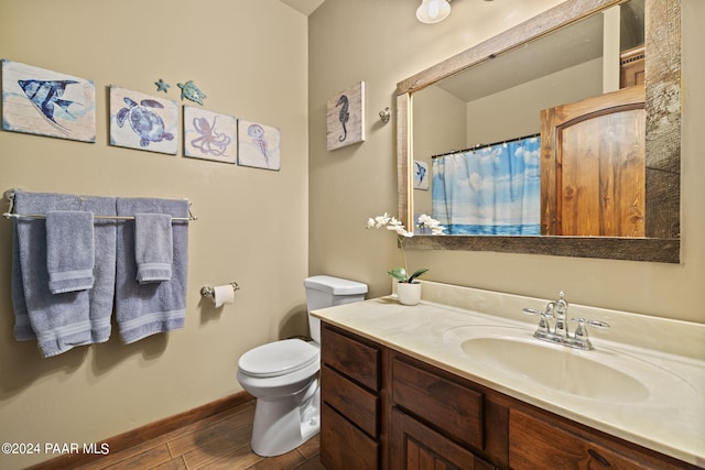 bathroom featuring hardwood / wood-style floors, vanity, and toilet