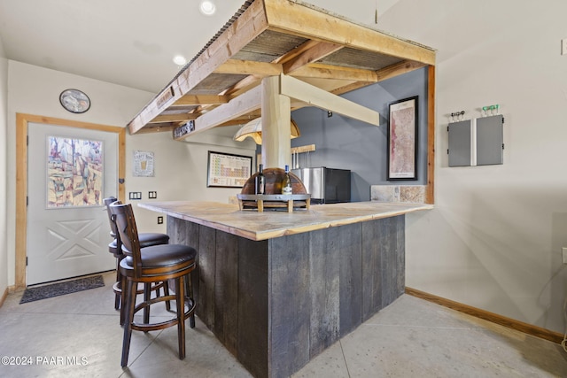 bar featuring stainless steel fridge