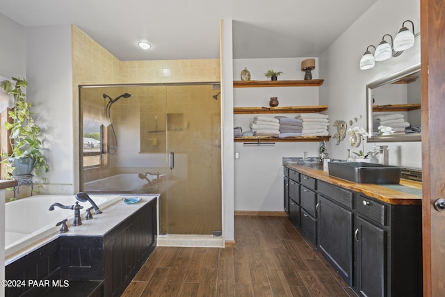 bathroom with vanity, wood-type flooring, and independent shower and bath