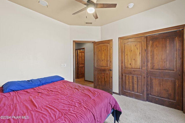 bedroom featuring ceiling fan and light carpet