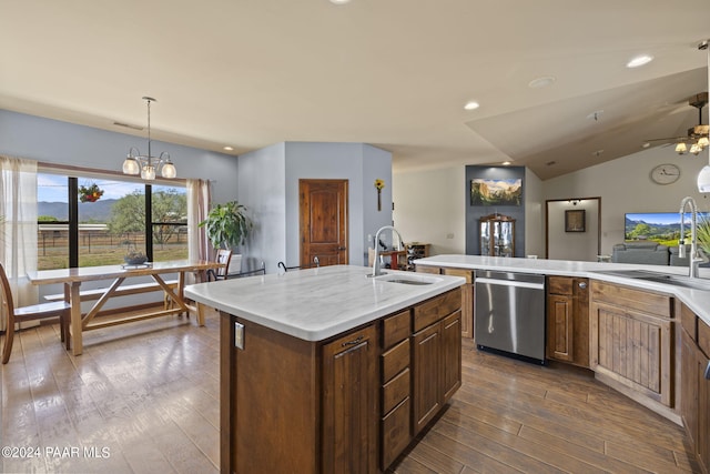 kitchen featuring dishwasher, sink, lofted ceiling, a center island with sink, and hardwood / wood-style flooring