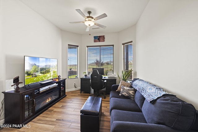 living room featuring light hardwood / wood-style flooring and ceiling fan