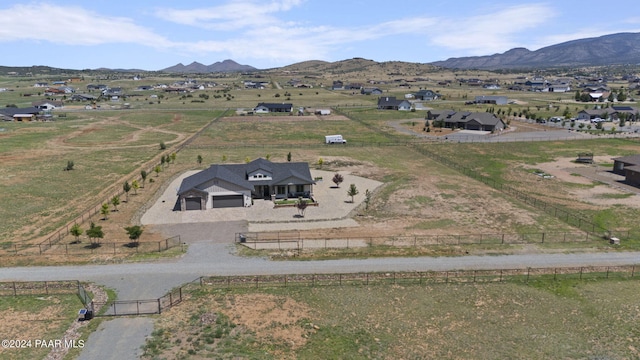 drone / aerial view featuring a mountain view and a rural view