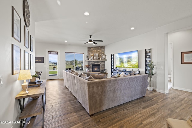 living room featuring a fireplace, ceiling fan, and dark hardwood / wood-style flooring