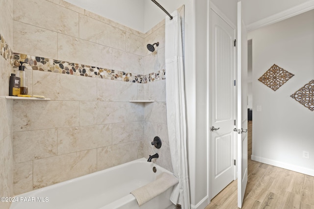 bathroom with wood-type flooring and shower / bath combo with shower curtain