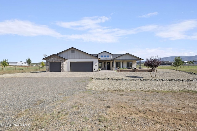 single story home with a mountain view and a garage