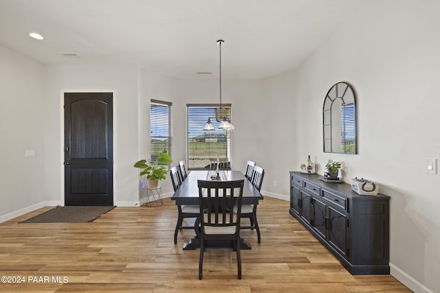 dining room featuring a chandelier and light wood-type flooring