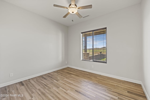 empty room with light hardwood / wood-style flooring and ceiling fan