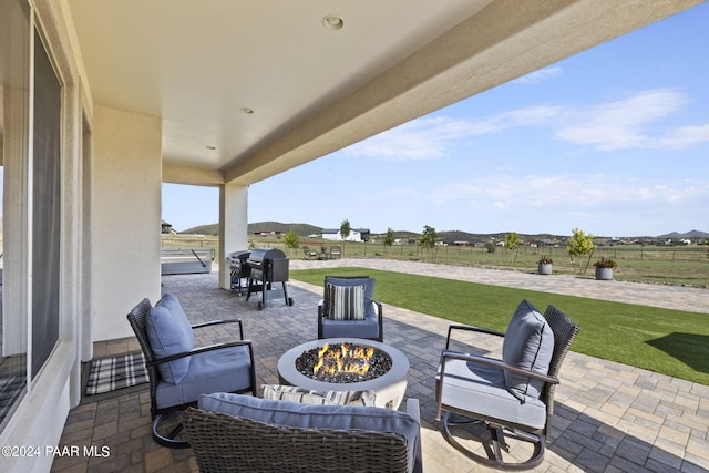 view of patio featuring area for grilling and a fire pit