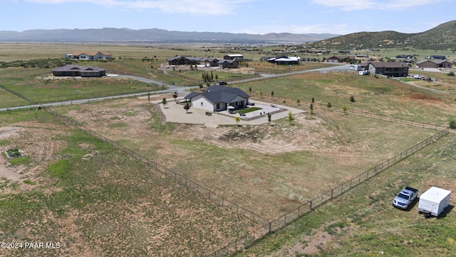 birds eye view of property featuring a mountain view and a rural view