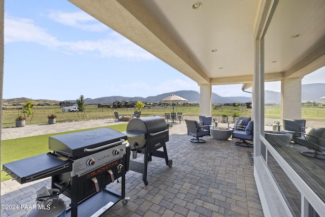 view of patio with a mountain view and grilling area