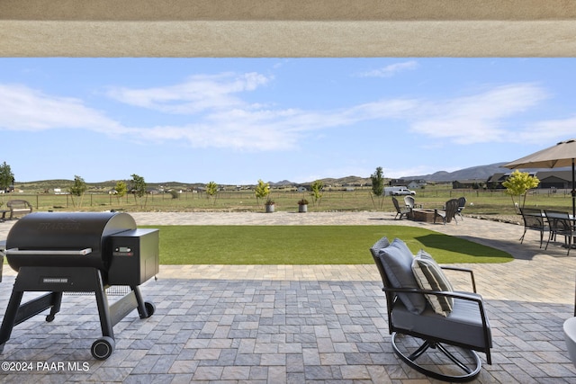 view of patio with a grill and a mountain view