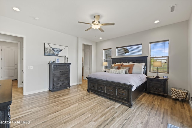 bedroom with ceiling fan and light hardwood / wood-style floors