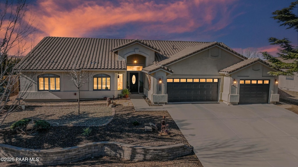 mediterranean / spanish home featuring a garage