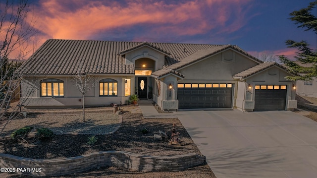 mediterranean / spanish home featuring a garage