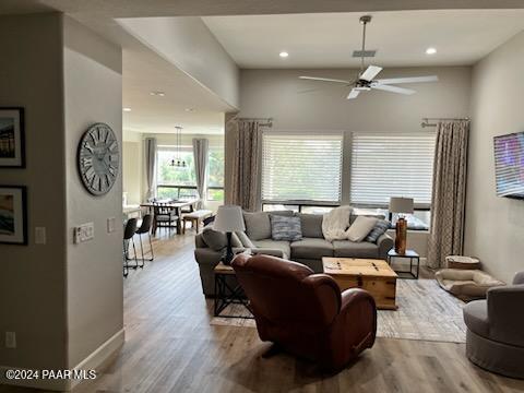 living room with ceiling fan and light hardwood / wood-style floors