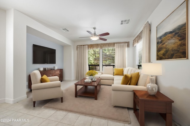 living room featuring light tile patterned floors and ceiling fan