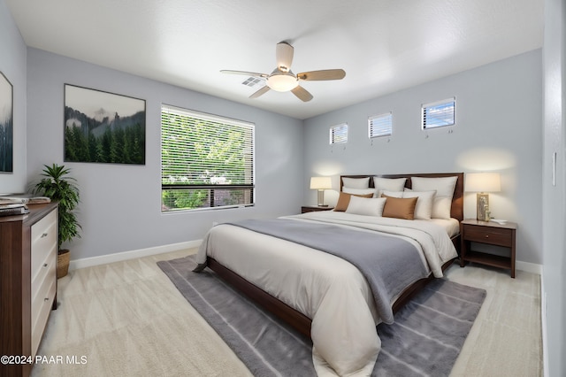 bedroom featuring light colored carpet and ceiling fan