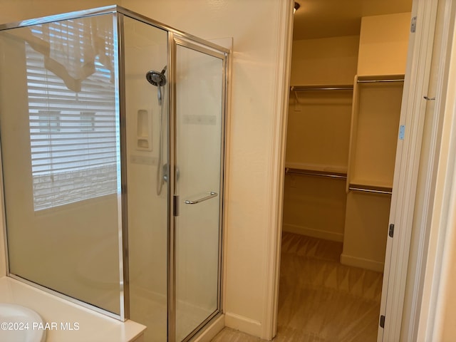 bathroom with a shower with door