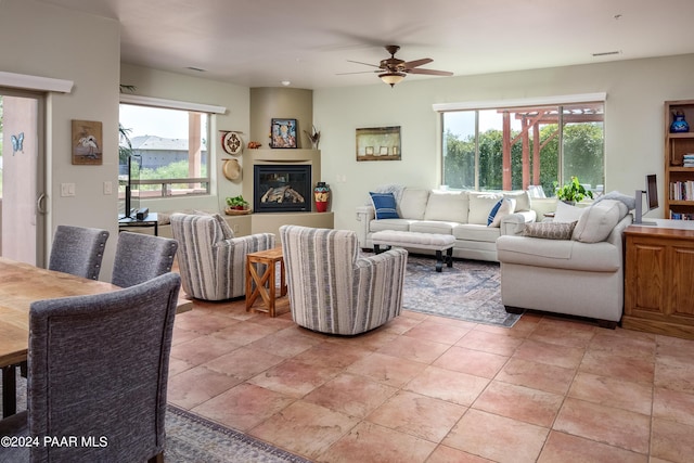 tiled living room with ceiling fan and a wealth of natural light