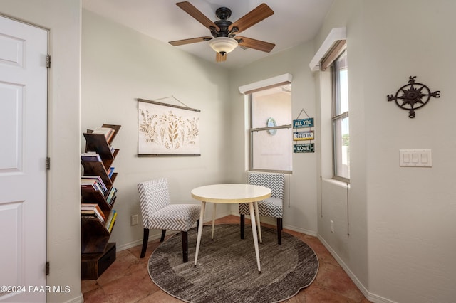 living area featuring ceiling fan and light tile patterned flooring