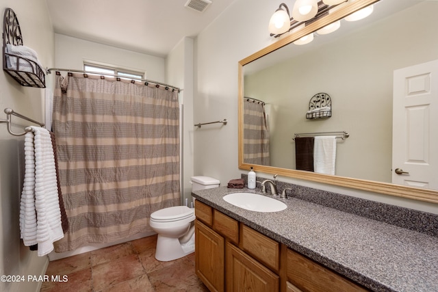 bathroom with a shower with shower curtain, vanity, and toilet