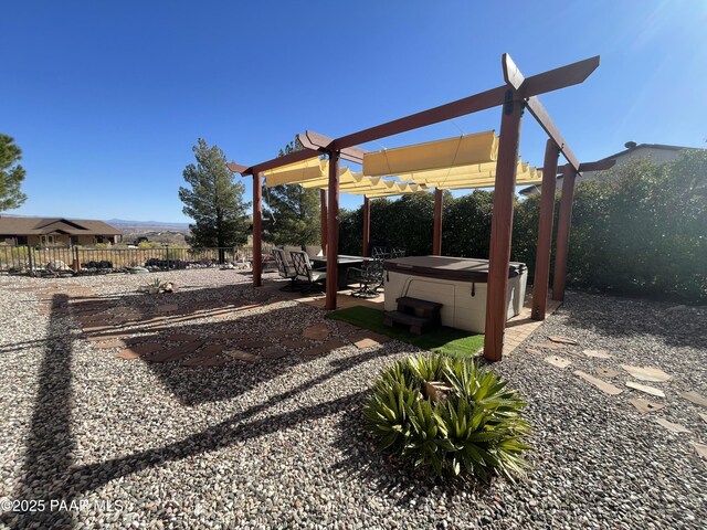 view of patio / terrace featuring a pergola and a hot tub