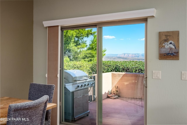 doorway to outside with a mountain view and a healthy amount of sunlight