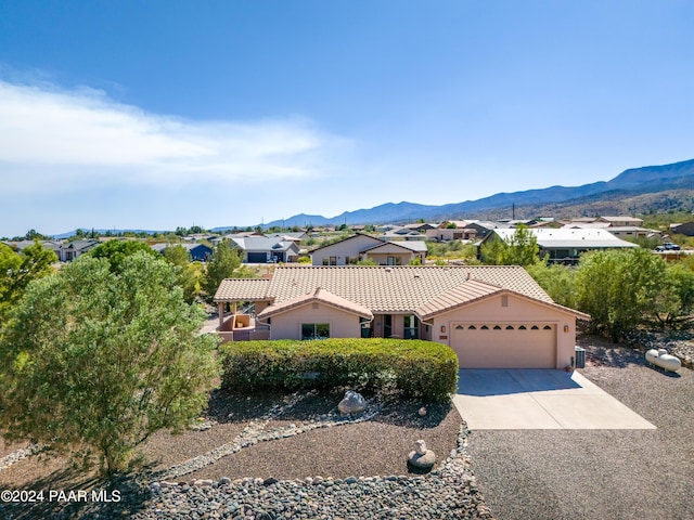 view of front of home featuring a mountain view and a garage