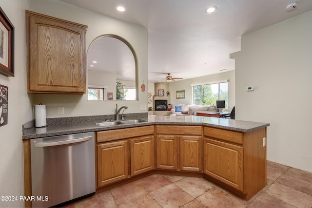 kitchen featuring stainless steel dishwasher, ceiling fan, kitchen peninsula, and sink