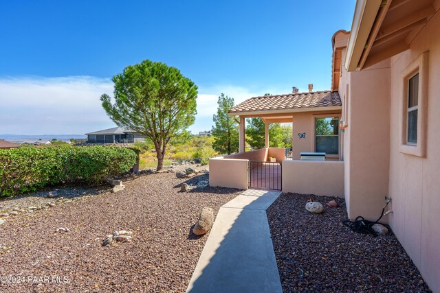 exterior space with a pergola, a patio area, and a hot tub