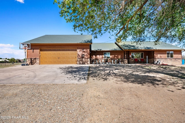 1501 W Kelly Dr, Prescott, AZ 86305 - view of front of property with concrete driveway, stone siding, and a garage