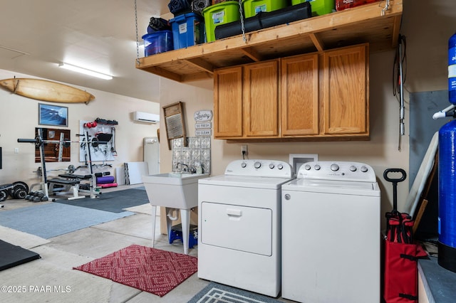 1501 W Kelly Dr, Prescott, AZ 86305 - laundry room featuring washing machine and dryer, cabinet space, and a wall mounted air conditioner