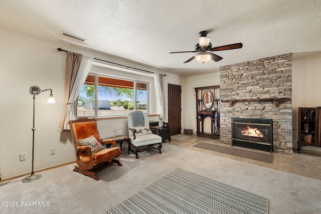 1501 W Kelly Dr, Prescott, AZ 86305 - sitting room featuring a ceiling fan, carpet flooring, a textured ceiling, and a stone fireplace
