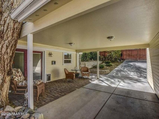 view of patio featuring fence