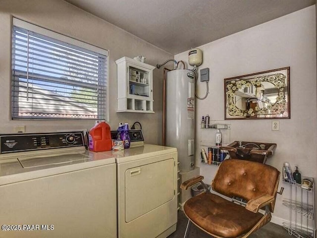 washroom featuring washing machine and clothes dryer, laundry area, and water heater