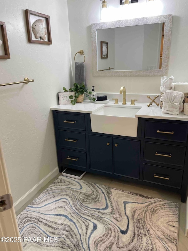 bathroom featuring baseboards and vanity