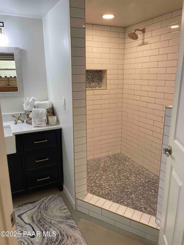 full bath with vanity, recessed lighting, and a tile shower