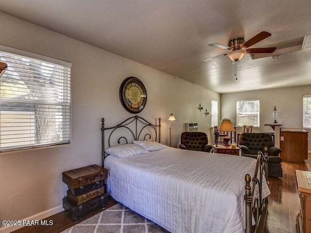 bedroom featuring wood finished floors, baseboards, and ceiling fan