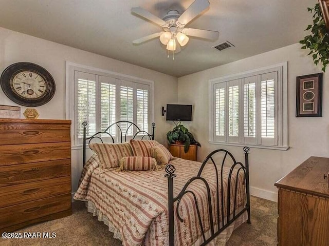 bedroom with visible vents, multiple windows, ceiling fan, and carpet floors