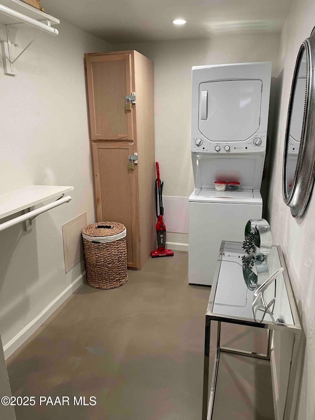 clothes washing area featuring recessed lighting, baseboards, stacked washer and dryer, and laundry area