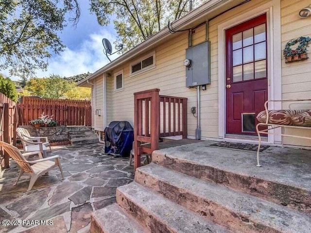 doorway to property featuring a patio and fence