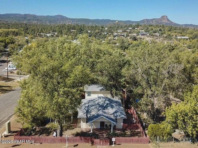 birds eye view of property with a mountain view and a forest view