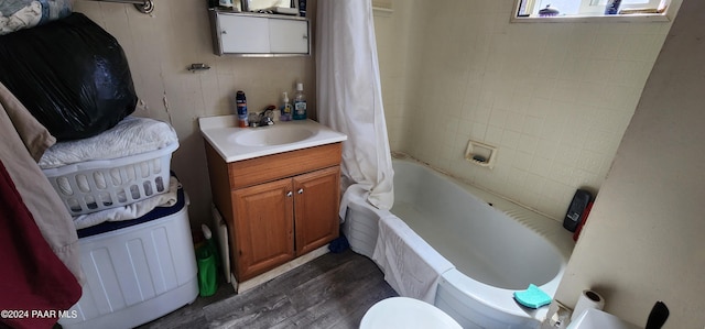 full bathroom featuring vanity, wood-type flooring, shower / tub combo, and toilet