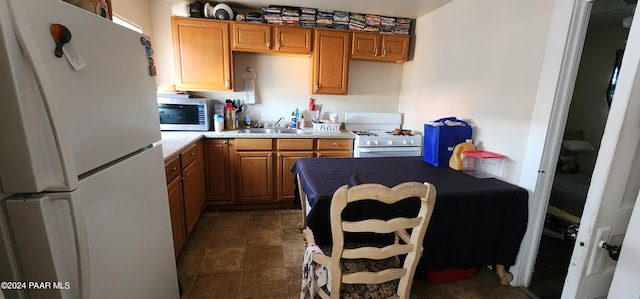 kitchen featuring white appliances and sink
