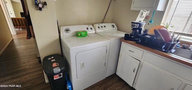 laundry room with separate washer and dryer and dark wood-type flooring
