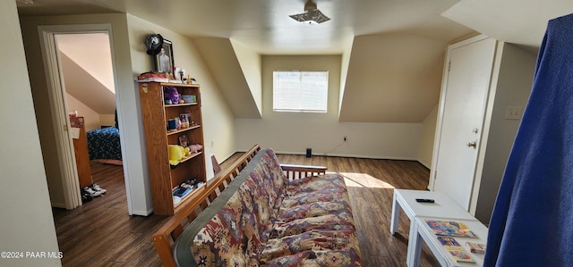 additional living space with vaulted ceiling and dark hardwood / wood-style floors
