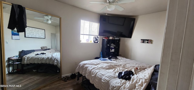 bedroom with dark hardwood / wood-style floors and ceiling fan