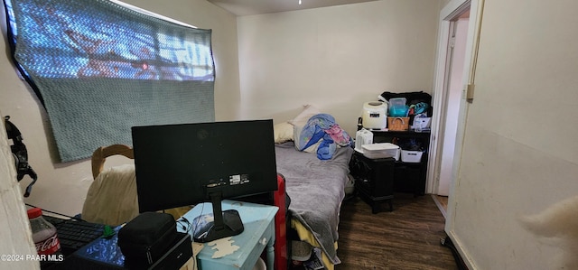 bedroom with dark wood-type flooring